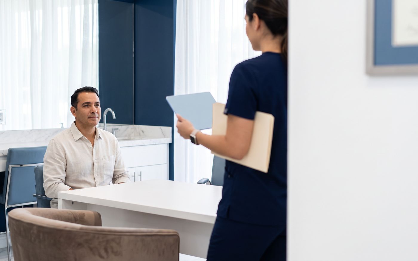 Consulenza sul costo del trapianto di capelli con il paziente che consulta un tablet